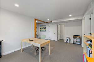 Carpeted office space featuring recessed lighting and baseboards