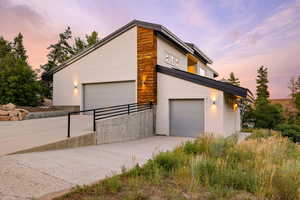 View of front of home featuring stucco siding and concrete driveway