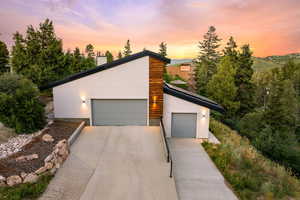 Contemporary house featuring stucco siding and a chimney