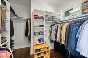 Walk in closet featuring wood finished floors