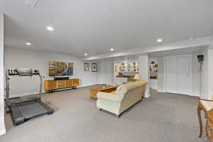Living area with carpet, recessed lighting, and a textured ceiling