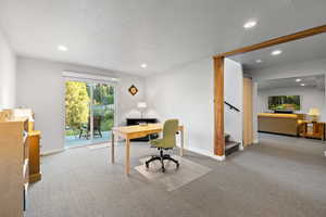 Carpeted office space featuring recessed lighting and a textured ceiling