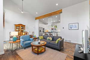 Living room with high vaulted ceiling, recessed lighting, a ceiling fan, and dark wood-type flooring