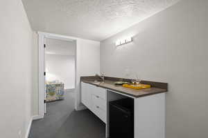Bathroom with a sink and a textured ceiling
