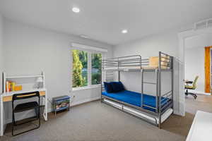 Carpeted bedroom featuring baseboards and recessed lighting