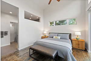 Bedroom with hardwood / wood-style floors, high vaulted ceiling, recessed lighting, and ceiling fan
