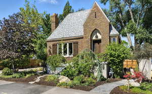 Tudor house with a shingled roof and a chimney