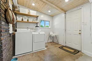 Washroom featuring washing machine and dryer, recessed lighting, and wood ceiling