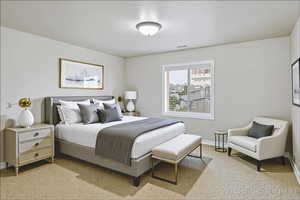 Bedroom with baseboards and light carpet