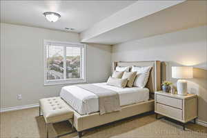 Carpeted bedroom with baseboards