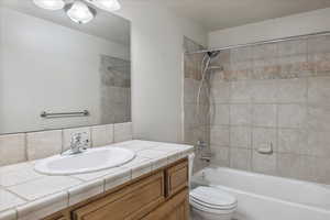 Bathroom with vanity and  shower combination