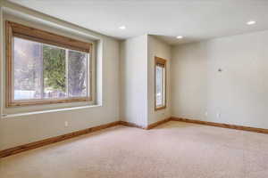 Empty room featuring light colored carpet and recessed lighting