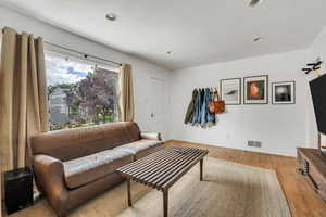 Living room featuring wood finished floors and recessed lighting