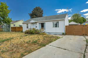 View of front of property with a gate and a shingled roof