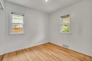 Unfurnished room featuring plenty of natural light, wood finished floors, and recessed lighting