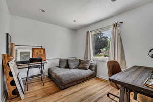 Home office with wood finished floors and baseboards