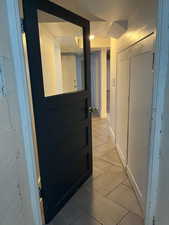 Hall featuring light tile patterned floors