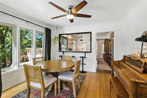 Dining area featuring light wood finished floors and a ceiling fan