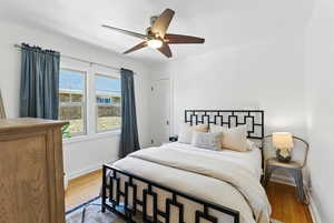 Bedroom featuring wood finished floors and ceiling fan