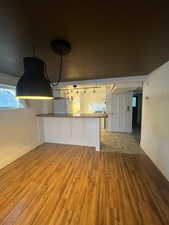 Unfurnished living room with light wood finished floors and baseboards