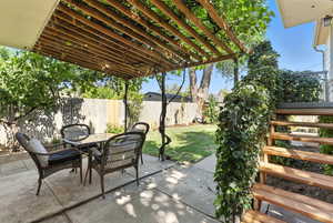 Fenced backyard featuring outdoor dining space and a patio area