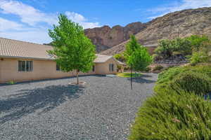 View of front facade with a mountain view, a tiled roof, and stucco siding