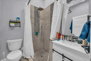 Bathroom with vanity and tiled shower