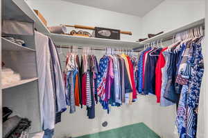 Walk in closet featuring carpet flooring