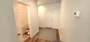Corridor featuring wood finished floors and baseboards