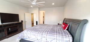 Carpeted bedroom featuring recessed lighting and a ceiling fan