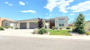 View of front of property featuring stucco siding, an attached garage, concrete driveway Summer 2025
