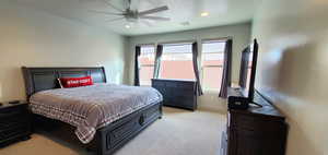 Primary bedroom with light carpet, a ceiling fan, and recessed lighting