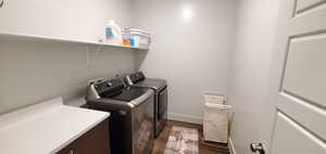 Laundry area with washing machine and clothes dryer and dark wood-style floors