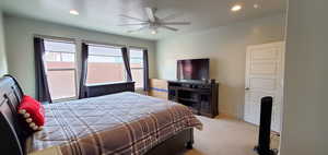Carpeted bedroom featuring recessed lighting and ceiling fan
