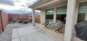 Fenced backyard featuring a patio and area for grilling