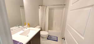 Full bath featuring vanity, tile patterned floors, and shower / tub combo with curtain