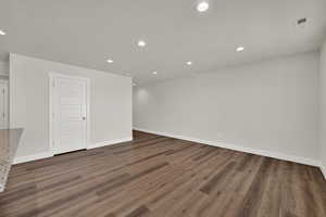 Unfurnished room featuring wood finished floors, recessed lighting, and a textured ceiling