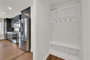 Mudroom featuring wood finished floors, recessed lighting, and a textured ceiling
