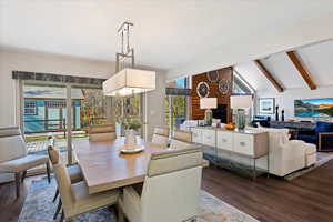 Formal Dining room with dark wood finished floors and a brick fireplace