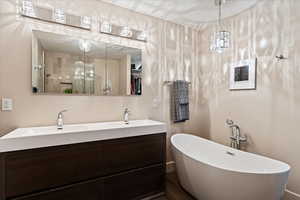 En Suite Primary Full bathroom featuring a soaking tub, double vanity, and a shower