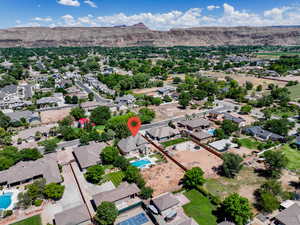 Aerial view of residential area featuring a pool area and mountains