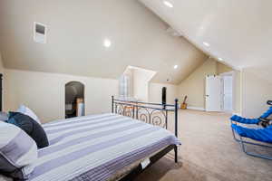 Bedroom with lofted ceiling, light colored carpet, and recessed lighting