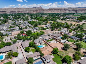 Aerial view of residential area with a pool and mountains