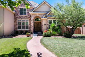 View of front of house featuring stone siding and stucco siding