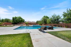 View of pool with a fenced backyard and a patio area