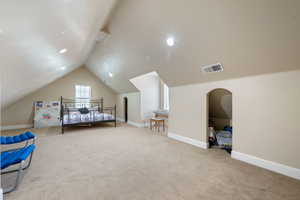 Bedroom featuring carpet flooring, vaulted ceiling, and recessed lighting