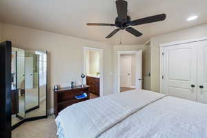 Bedroom featuring light carpet, a closet, and ceiling fan