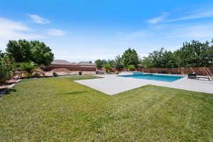 View of swimming pool with a fenced backyard and a patio area