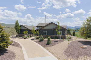 View of front of house with stone siding and a mountain view