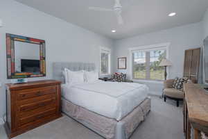 Carpeted bedroom featuring recessed lighting and a ceiling fan